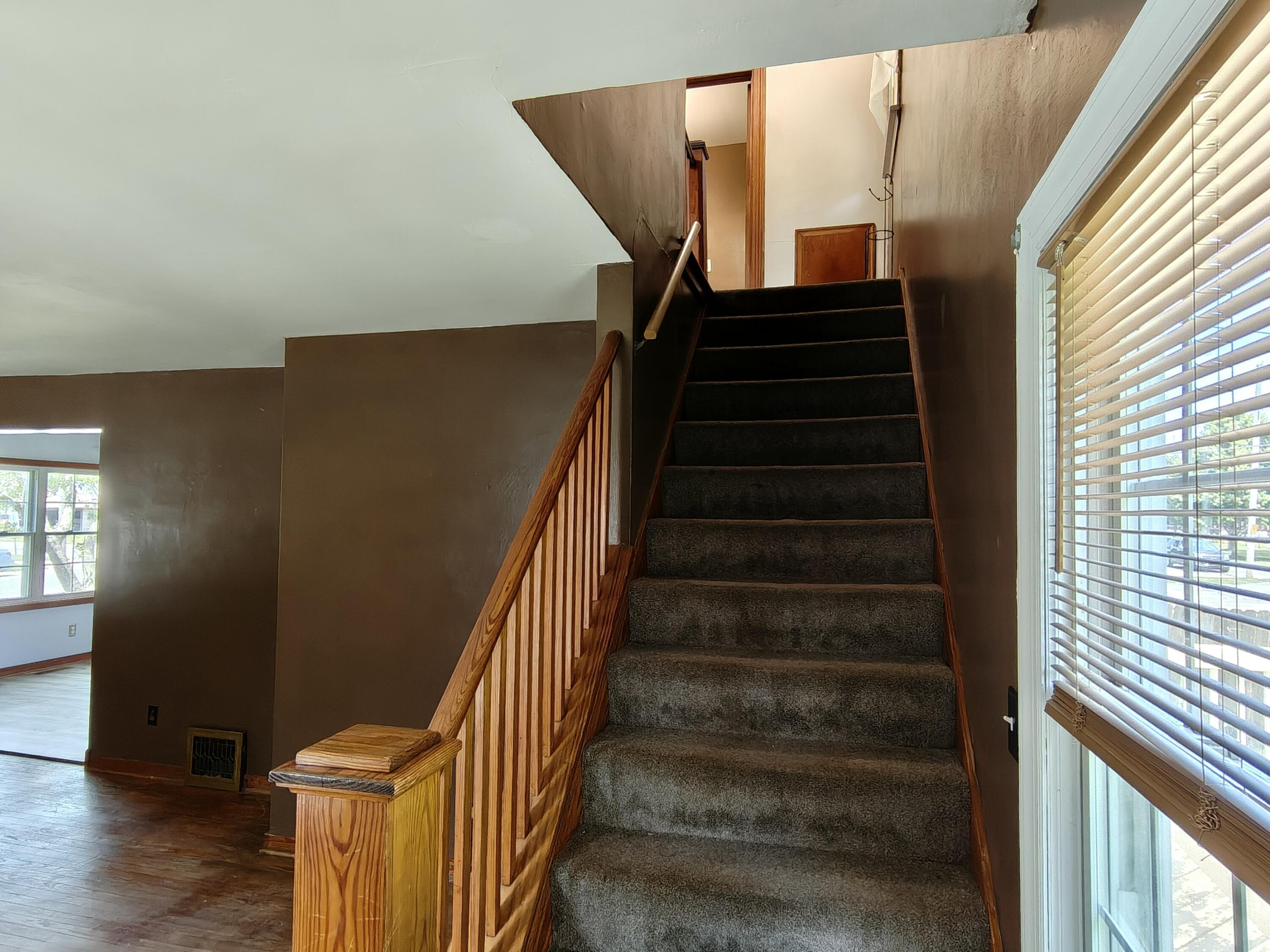 245 North Indiana Street Griffith, IN 46319 - Photo 11 of 30 a view of entryway with wooden floor and stairs