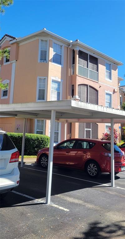13572 Turtle Marsh Loop, Unit 213 Orlando, FL 32837 - Photo 1 of 1 a front view of a building with parking space