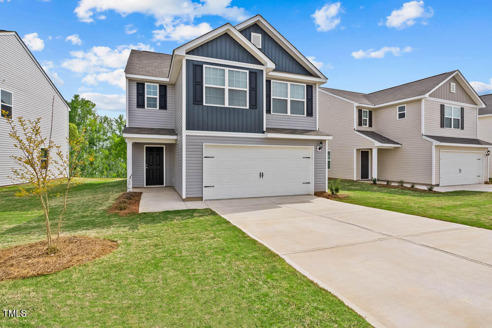 a front view of a house with a yard and garage