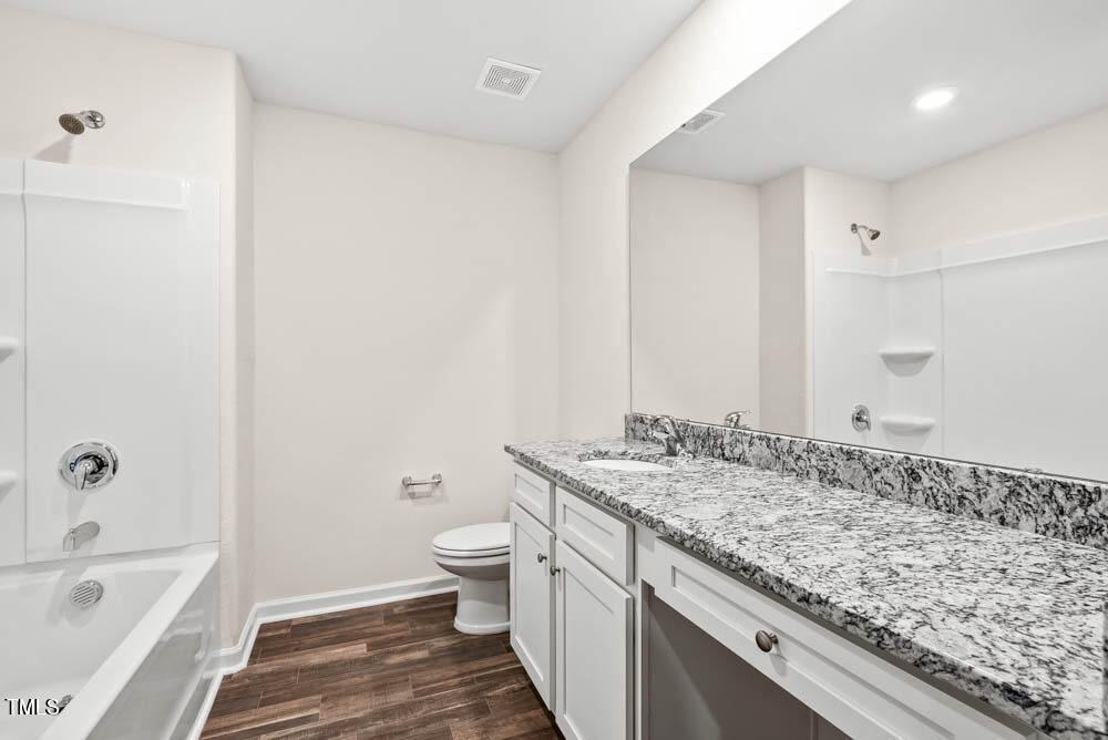 442 Crow Field Street Roxboro, NC 27574 - Photo 17 of 18 a bathroom with a granite countertop sink and a bathtub