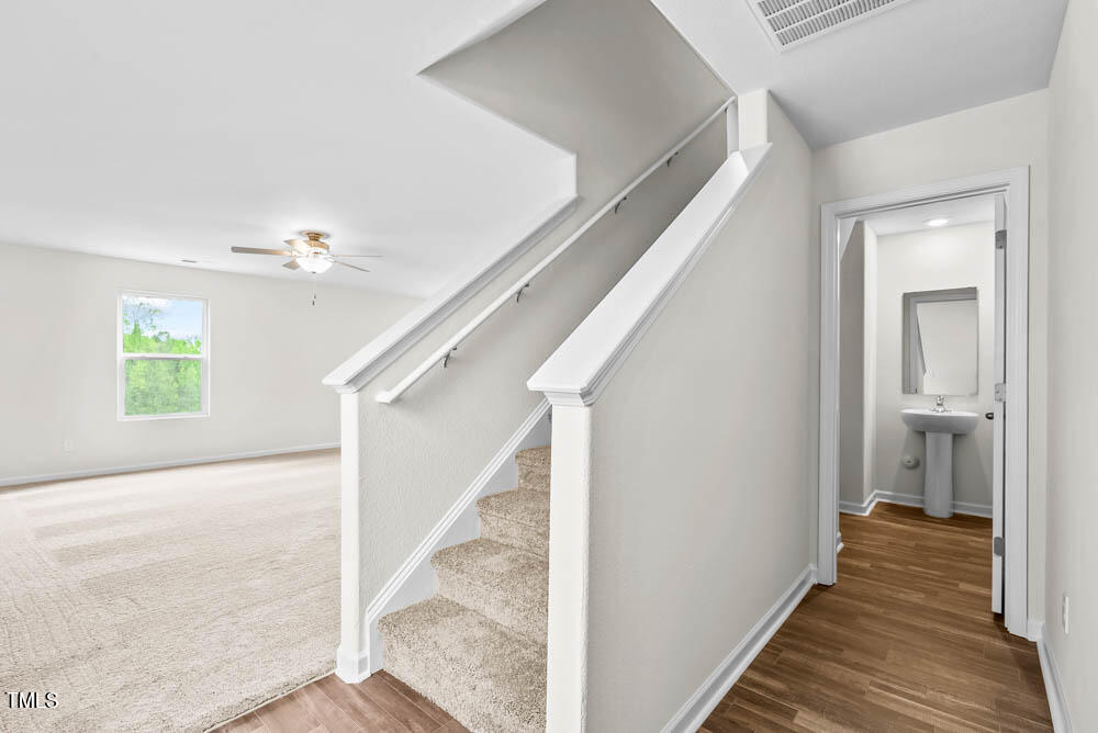 442 Crow Field Street Roxboro, NC 27574 - Photo 10 of 18 a view of a hallway with wooden floor and staircase