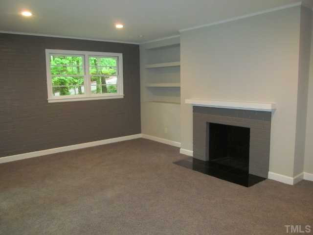 3444 Rugby Road Durham, NC 27707 - Photo 18 of 24 This fireplace is in the family room. Custom shelving on both sides of fireplace with granite hearth.