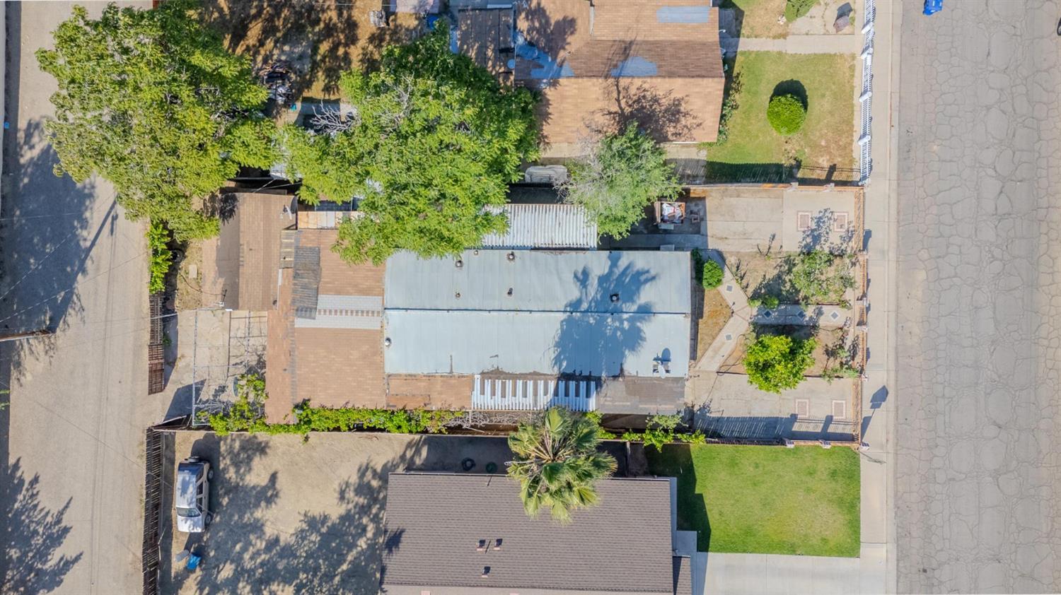 108 West Merced Street Avenal, CA 93204 - Photo 2 of 11 an aerial view of a house with a yard and a large tree