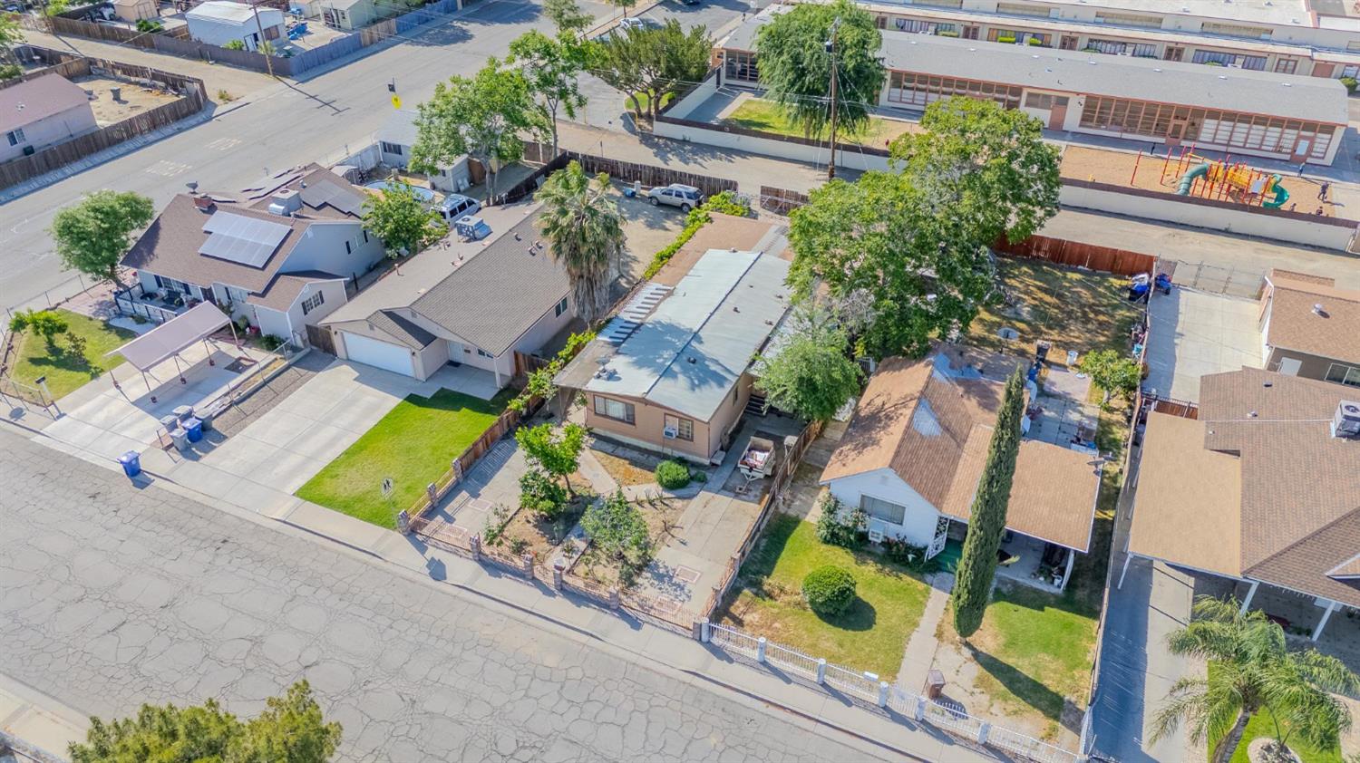 108 West Merced Street Avenal, CA 93204 - Photo 3 of 11 an aerial view of a house with a yard and outdoor seating