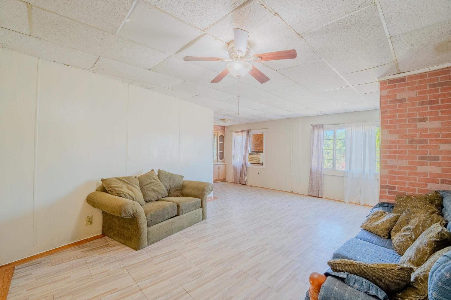 108 West Merced Street Avenal, CA 93204 - Photo 5 of 11 a living room with furniture and a wooden floor