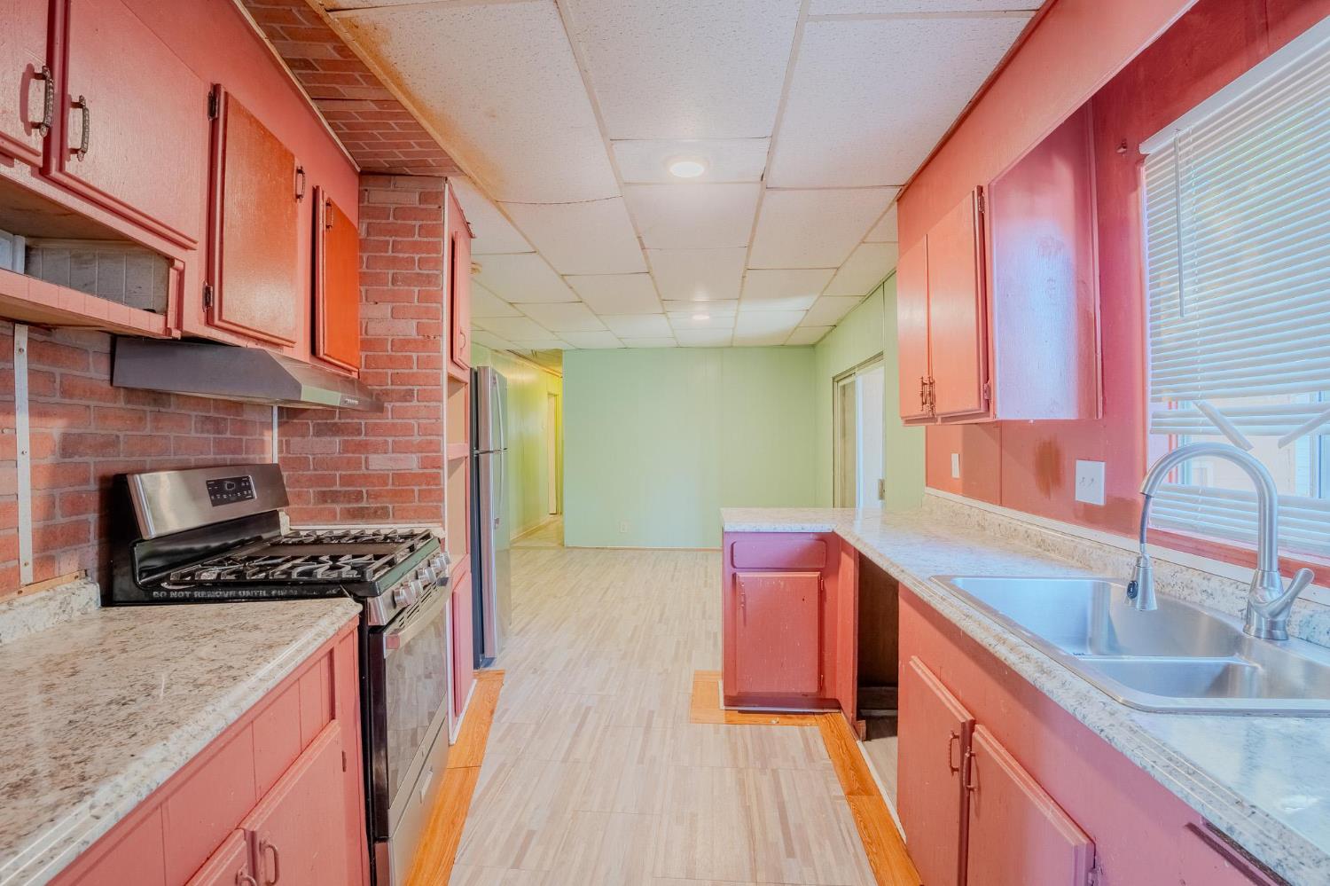 108 West Merced Street Avenal, CA 93204 - Photo 7 of 11 a kitchen that has a sink and a stove
