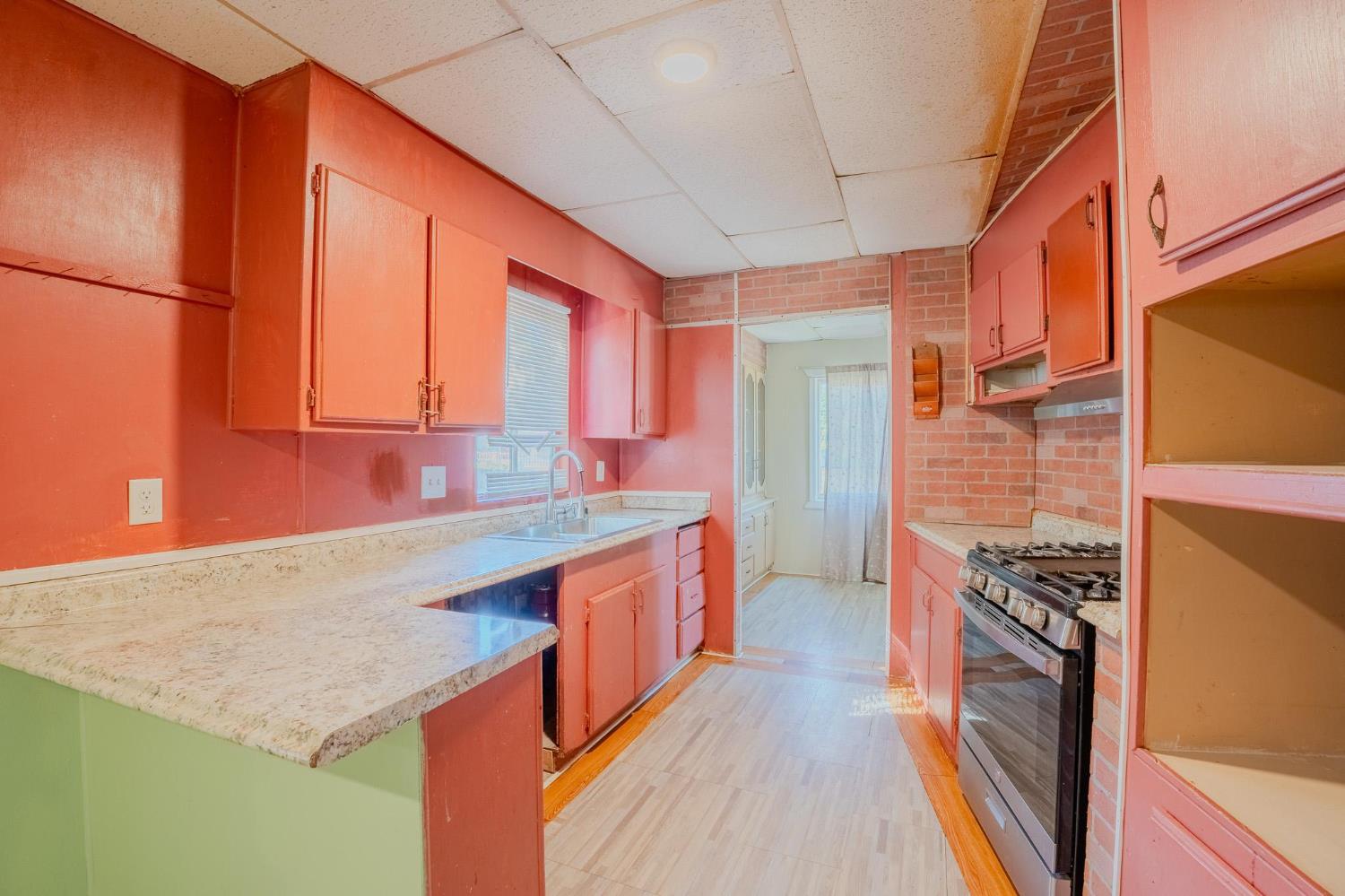 108 West Merced Street Avenal, CA 93204 - Photo 8 of 11 a kitchen with stainless steel appliances granite countertop a sink and a stove