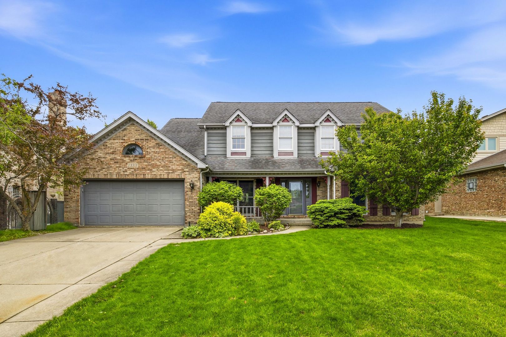 1333 Sable Drive Addison, IL 60101 - Photo 1 of 29 a front view of a house with a garden and yard