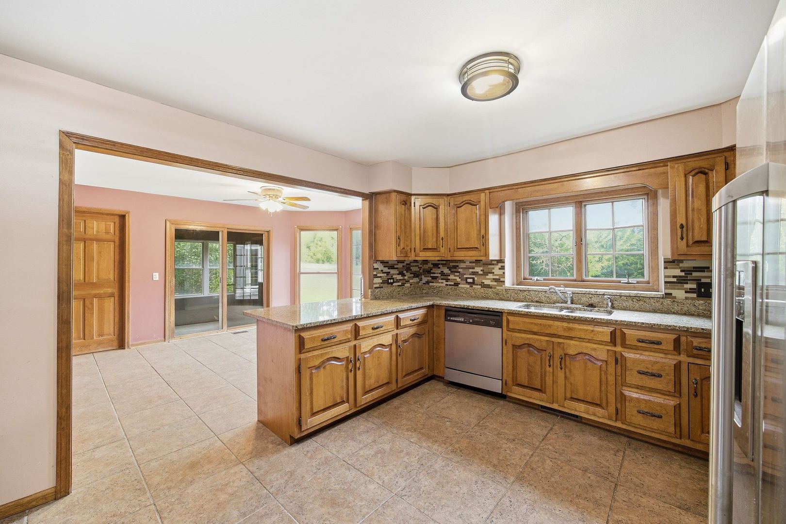 1333 Sable Drive Addison, IL 60101 - Photo 11 of 29 a large kitchen with stainless steel appliances granite countertop a large window and a sink