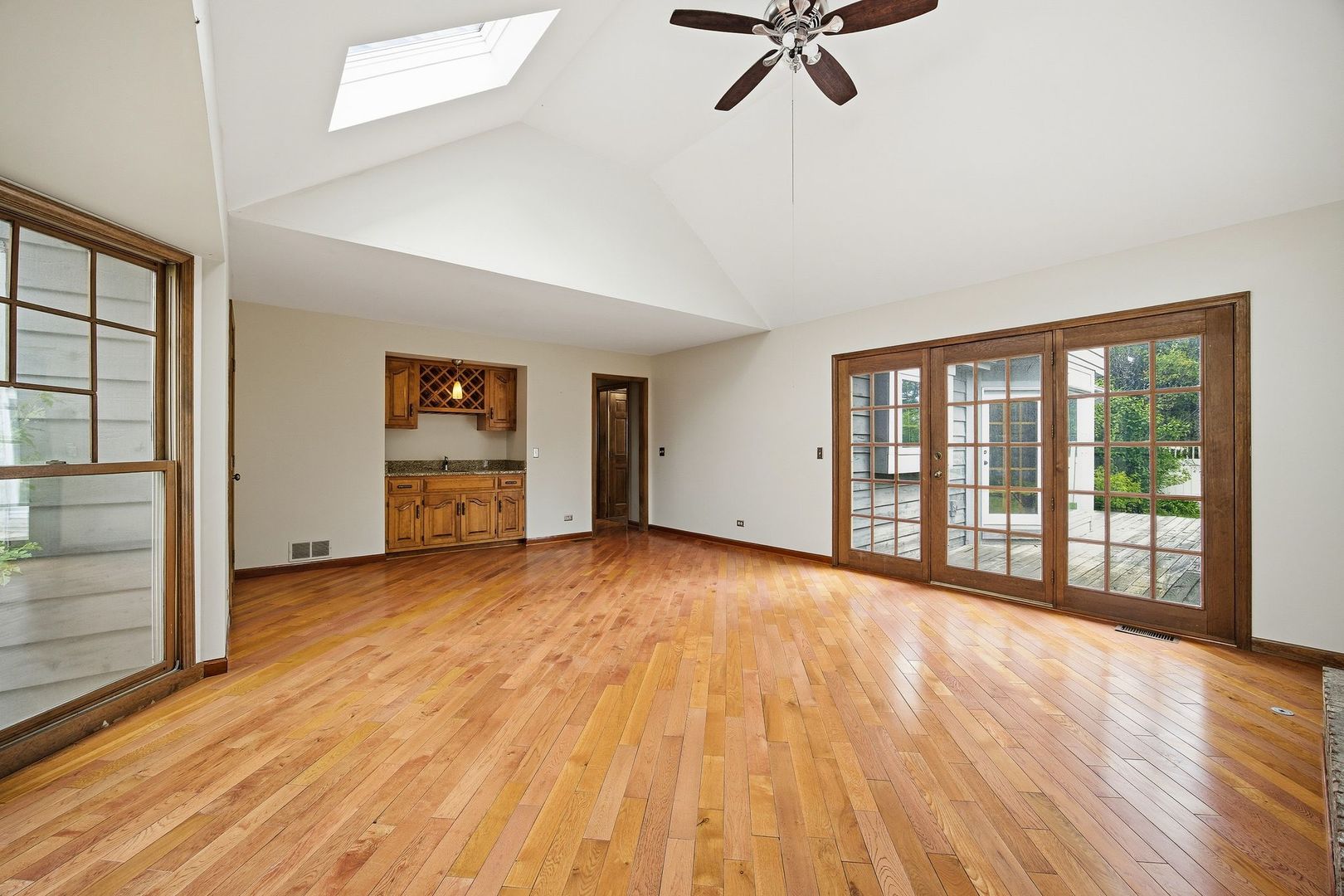 1333 Sable Drive Addison, IL 60101 - Photo 13 of 29 a view of an empty room with a window and wooden floor