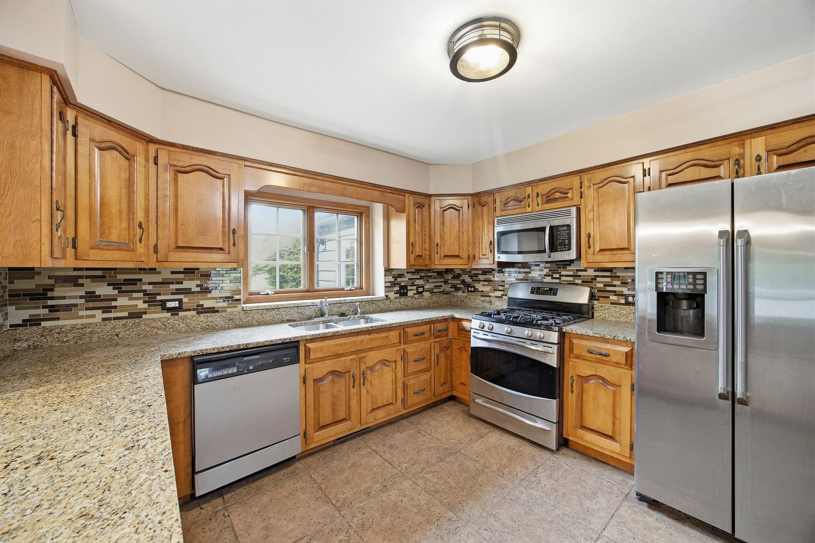 1333 Sable Drive Addison, IL 60101 - Photo 9 of 29 a kitchen with stainless steel appliances granite countertop a stove top oven a sink and dishwasher