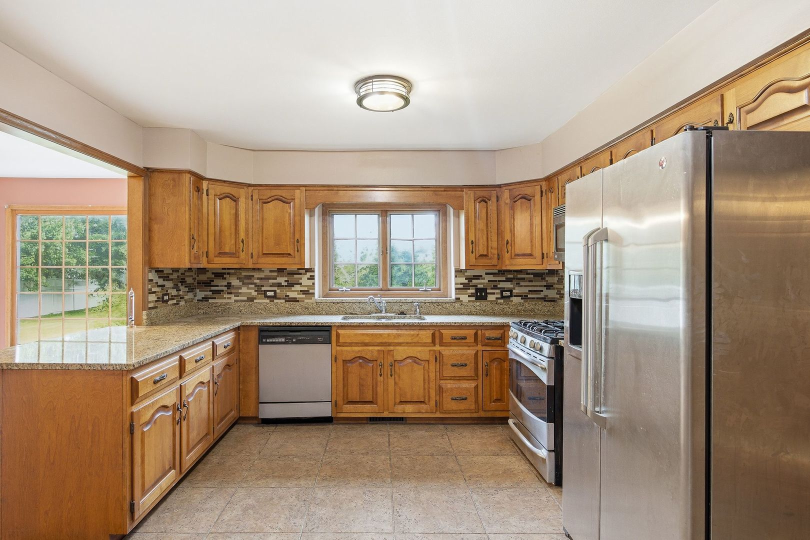 1333 Sable Drive Addison, IL 60101 - Photo 10 of 29 a large kitchen with stainless steel appliances granite countertop a refrigerator and a stove top oven