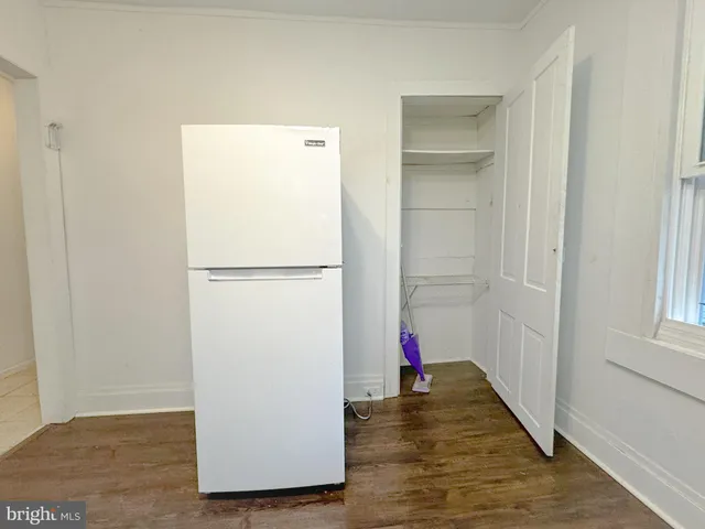 a view of walk in closet with wooden floor