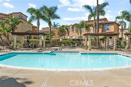 3603 Jetty Carlsbad, CA 92010 - Photo 39 of 43 a house with a swimming pool and outdoor seating