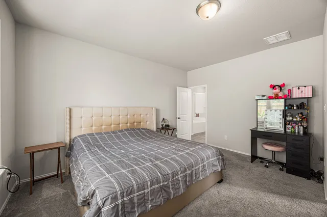 a bedroom with a bed and a desk