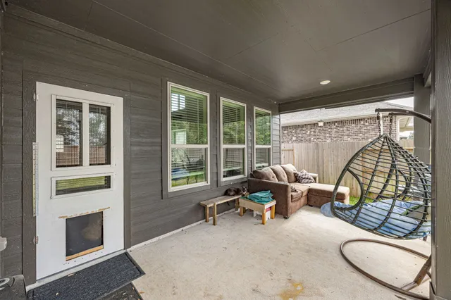 a living room with furniture and a floor to ceiling window