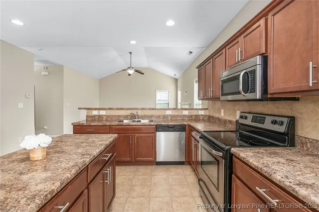 a kitchen with stainless steel appliances granite countertop a stove and a sink