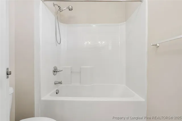a bathroom with a shower and a bath tub