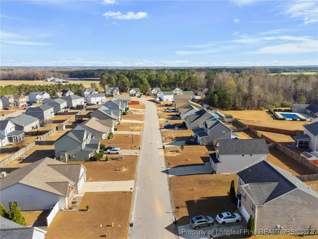 an aerial view of a house with swimming pool and mountain view in back