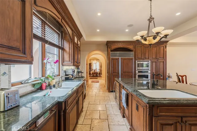 a kitchen with stainless steel appliances granite countertop a stove and a sink