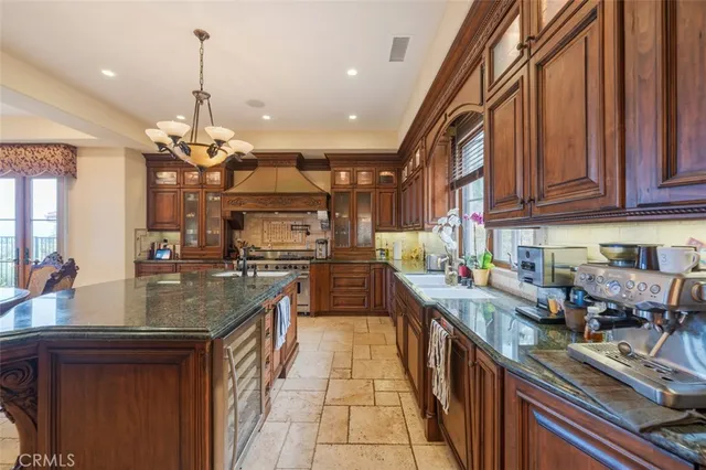 a bathroom with a granite countertop sink a toilet a mirror and shower