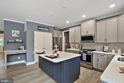 a kitchen with a sink stove and wooden cabinets