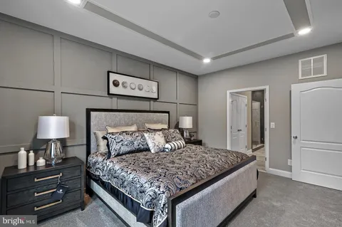 a spacious bathroom with a granite countertop sink a toilet a mirror and shower