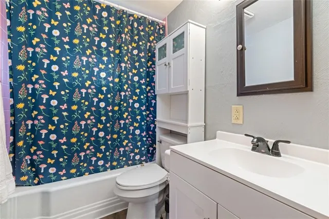 a bathroom with a sink toilet and mirror