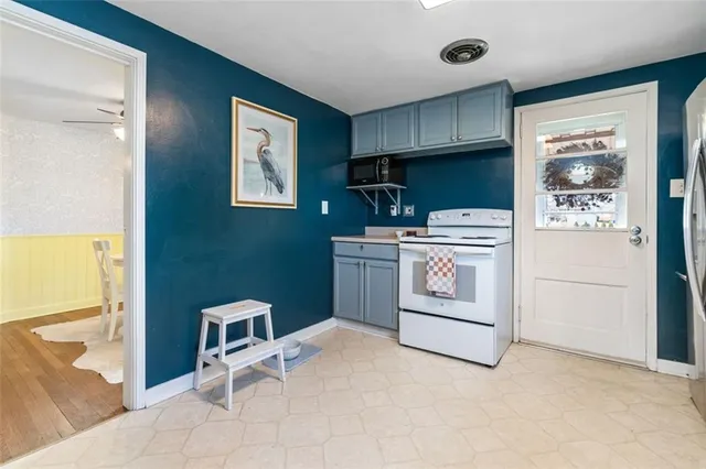 a kitchen with a stove top oven and cabinets