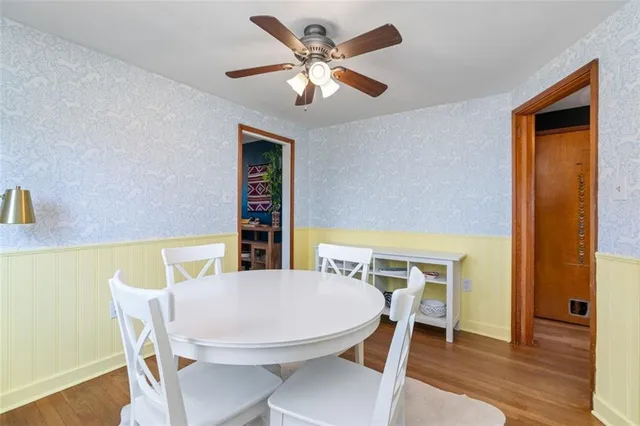 a view of a dining room with furniture and wooden floor