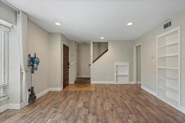 wooden floor in an empty room with a window