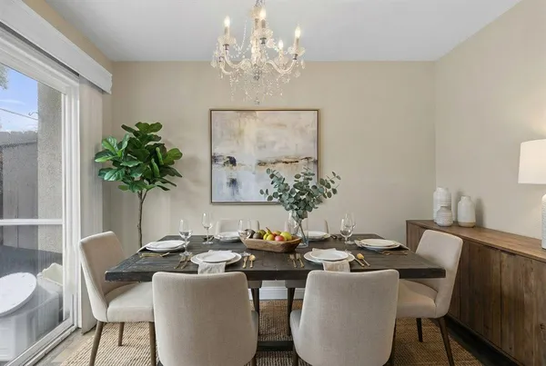 a view of a room with wooden floor and a chandelier