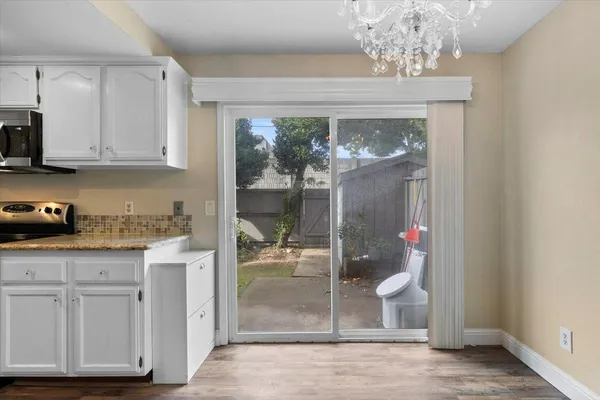 a kitchen with stainless steel appliances granite countertop a sink and a stove