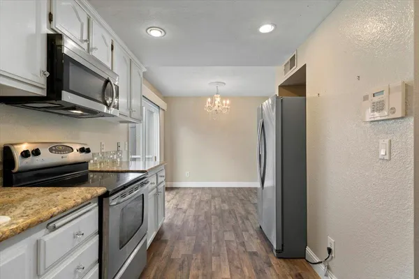 a view of a hallway with a chandelier