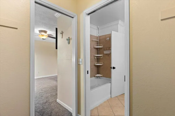 an empty room with a window and a ceiling fan