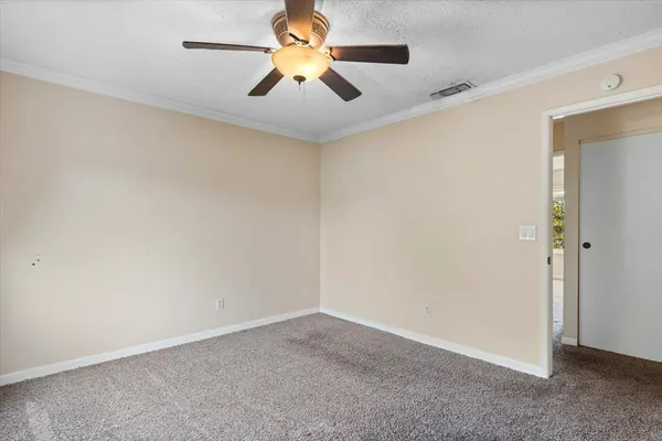 a view of empty room with wooden floor and window