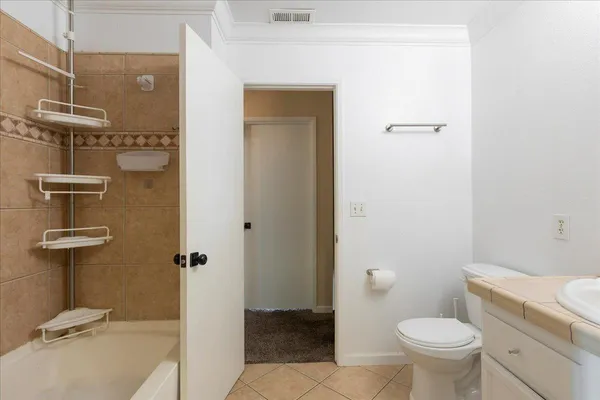 a view of backyard with table and chairs and a large tree