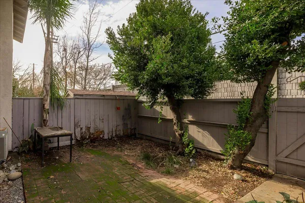 a backyard of a house with table and chairs