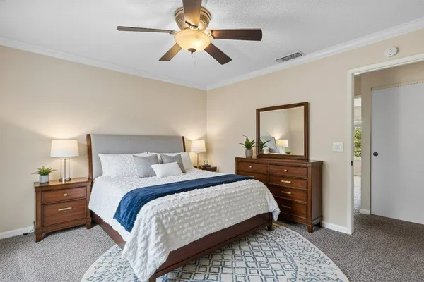 a bedroom with a bed and a mirror on dresser