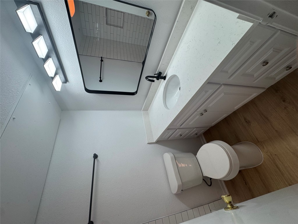 2110 Rio Grande Street, Unit 107 Austin, TX 78705 - Photo 3 of 9 a bathroom with a toilet sink and mirror