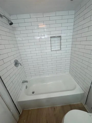 a bathroom with a bathtub and shower