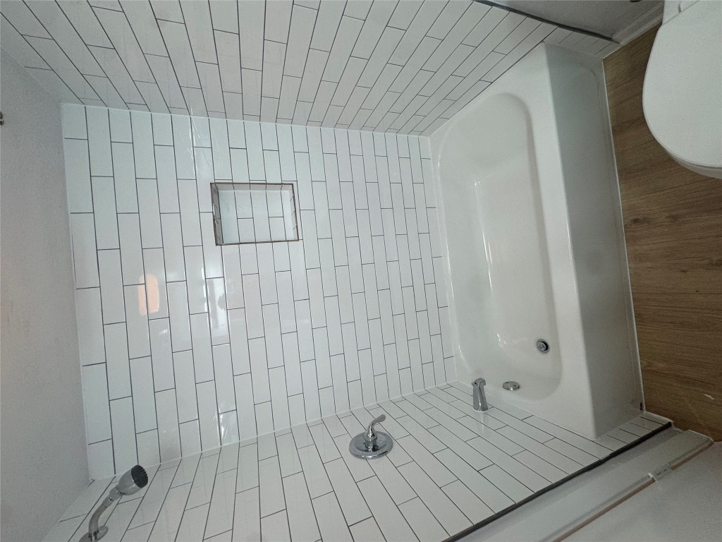 2110 Rio Grande Street, Unit 107 Austin, TX 78705 - Photo 10 of 10 a bathroom with a bathtub and shower