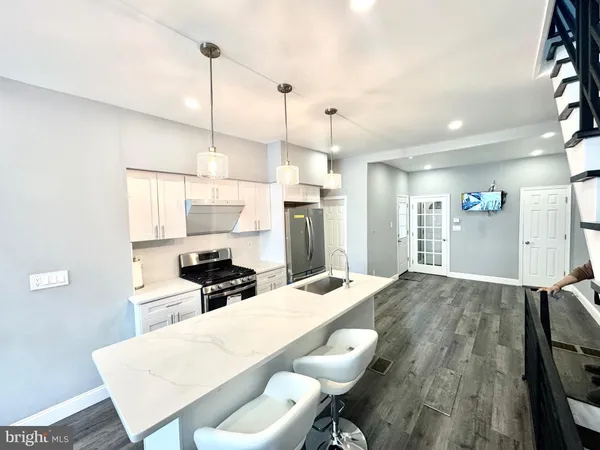 a kitchen with a table chairs refrigerator and microwave