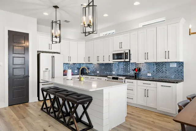 a living room with furniture and kitchen view