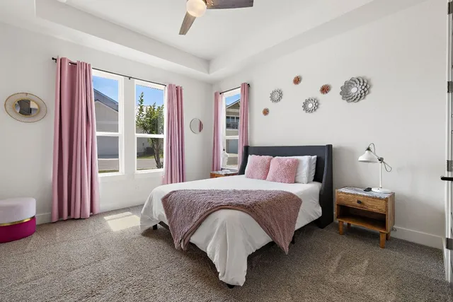 a bed sitting in a bedroom next to a window