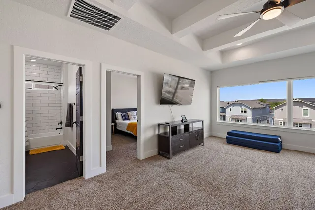 a bedroom with furniture and a ceiling fan