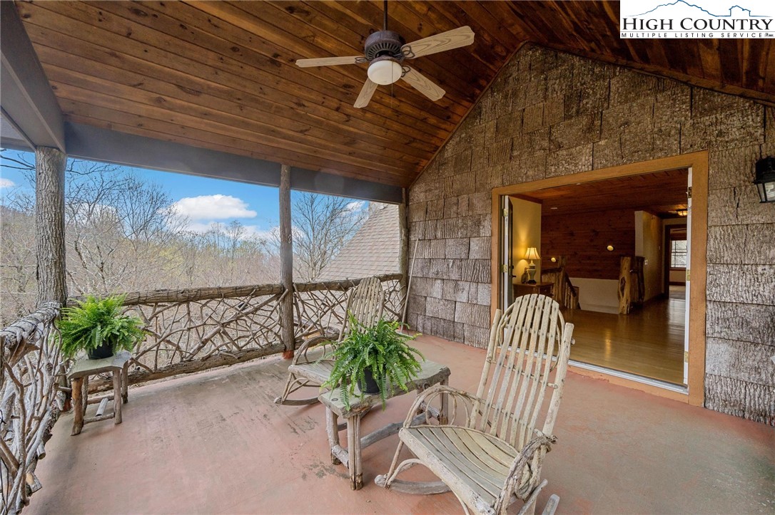 140 Spruce Hollow Road Beech Mountain, NC 28604 - Photo 25 of 50 a view of a porch with chairs and a potted plant