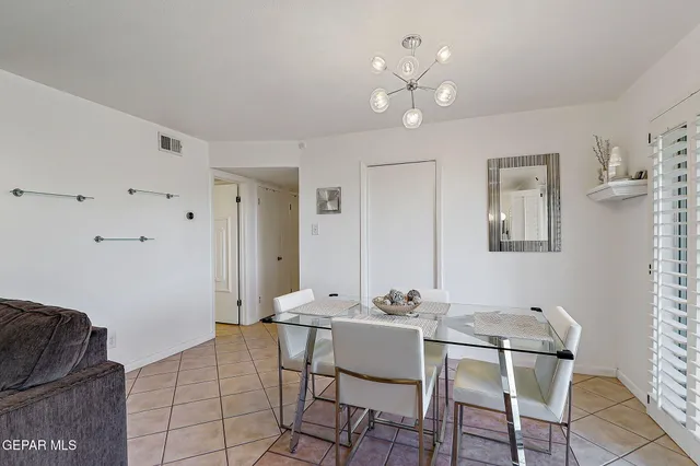 a kitchen with stainless steel appliances granite countertop a refrigerator a stove and a sink with wooden floor