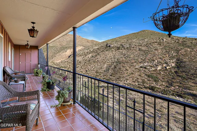 a view of swimming pool with outdoor seating and trees in the background