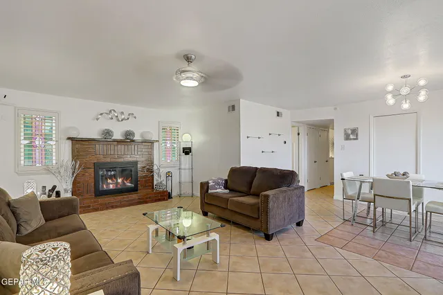 a view of a dining room with furniture and chandelier